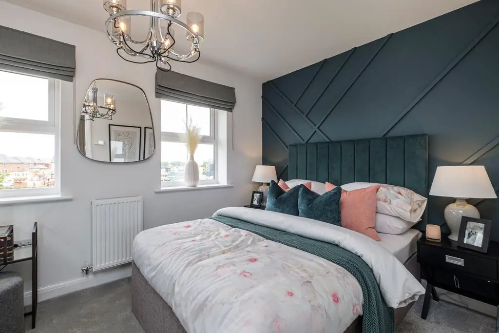 Double bedroom with blue panelled wall and two...