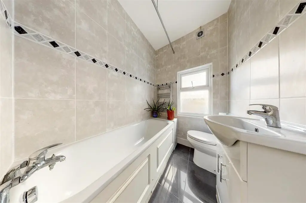 Fully tiled modern fitted bathroom combined W.C