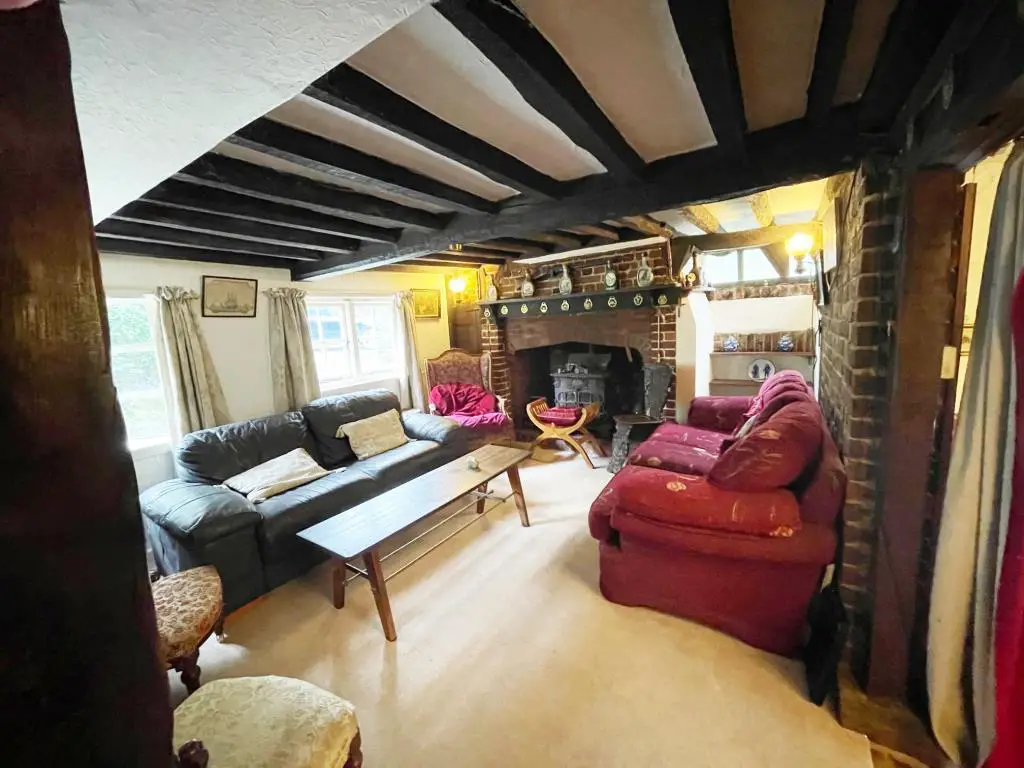 Living room with inglenook fireplace in cottage in