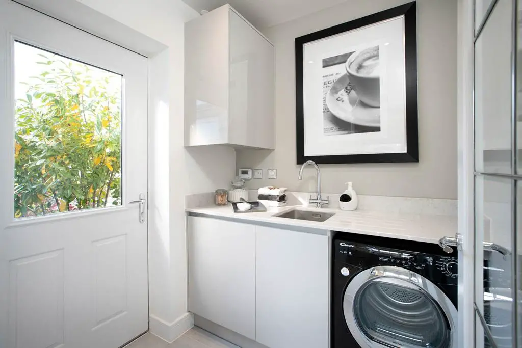 Separate utility room provides space for the...