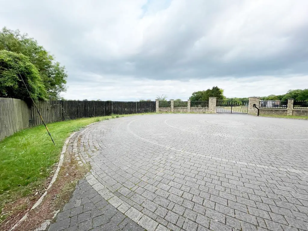 The land is situated behind the fence on the land