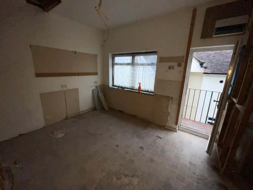 Former kitchen stripped back