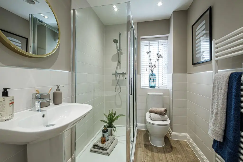 En suite with glass shower cubicle and white...