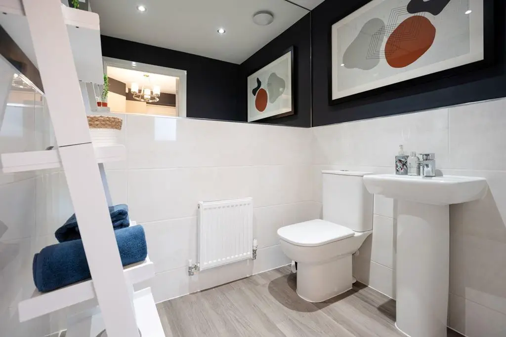 A large cloakroom provides space for a washing...