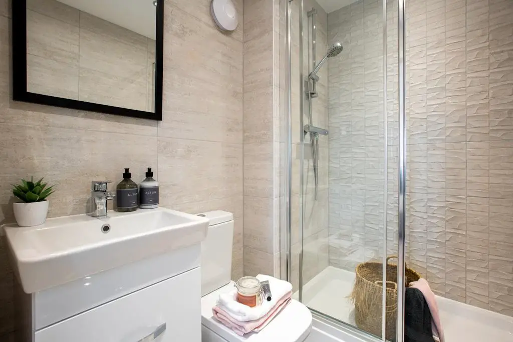 The en suite benefits from a large double shower