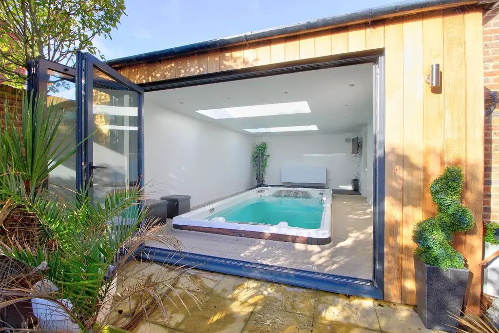Fitness pool with bifold doors and shower room
