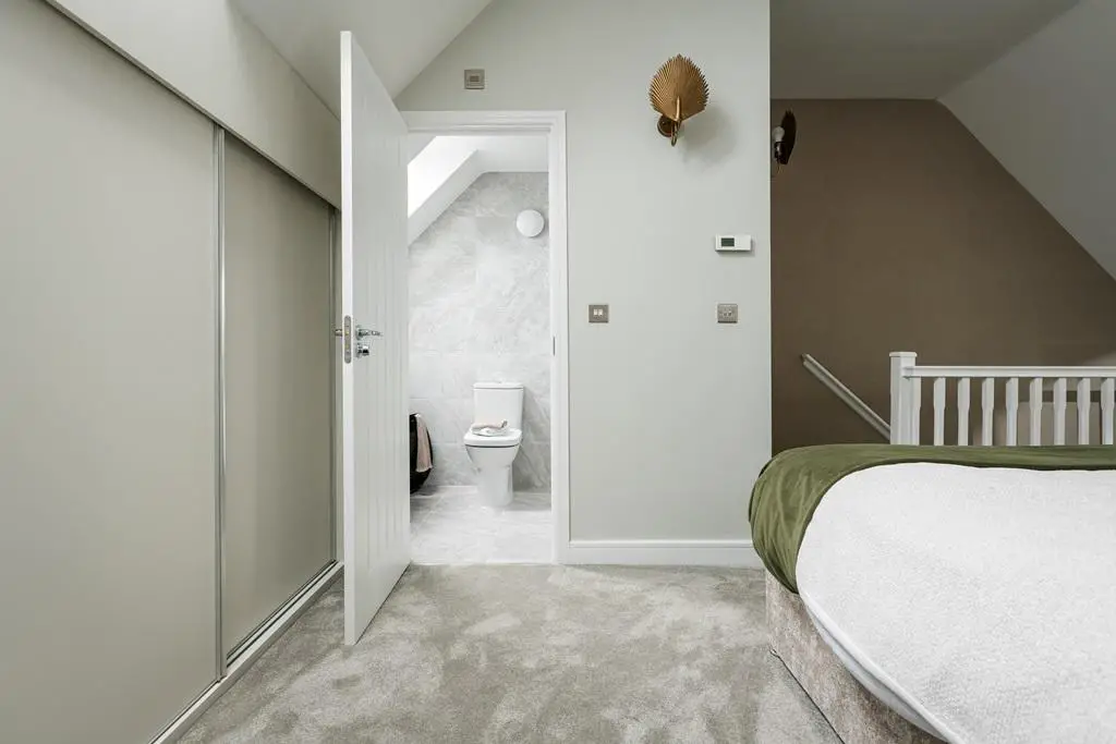 The master bedroom features an en suite &amp; built...