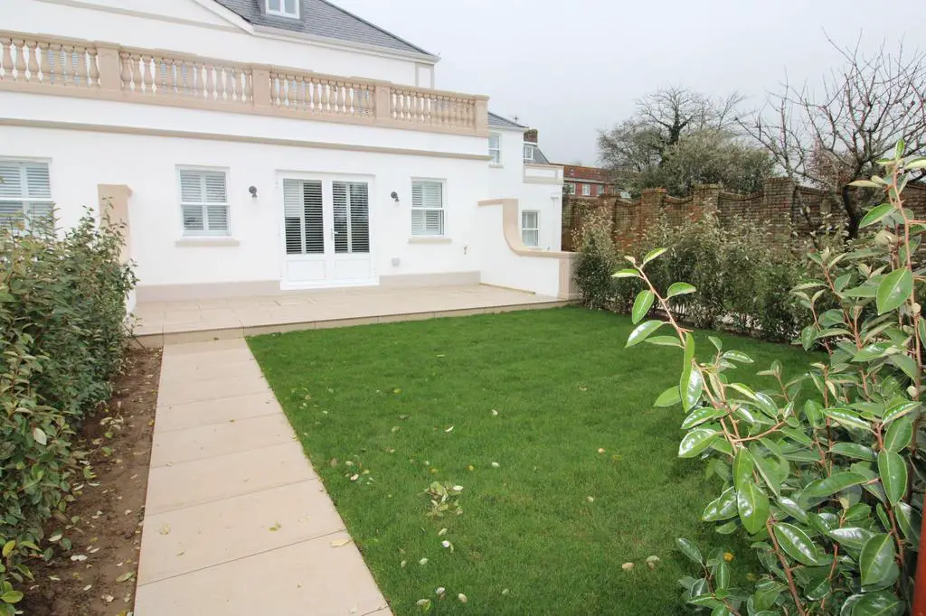 Private enclosed lawned garden and patio area