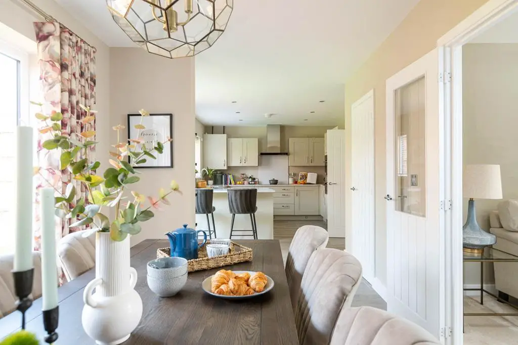 An open plan kitchen dining room is designed...