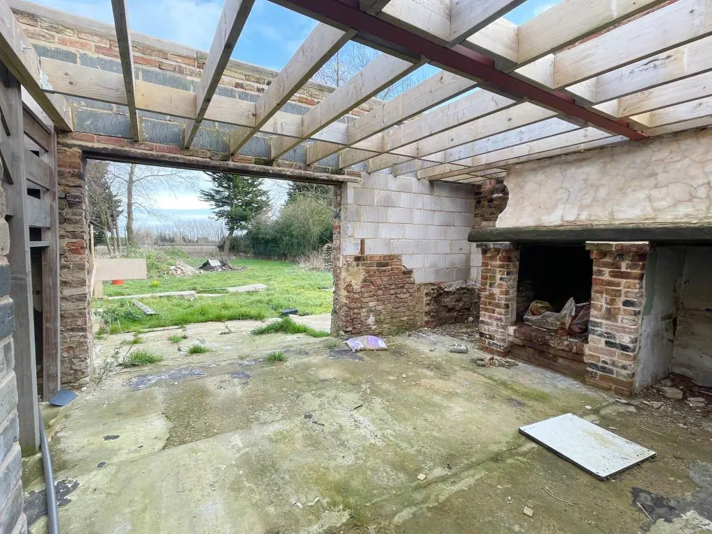 Ground floor fireplace and view to rear