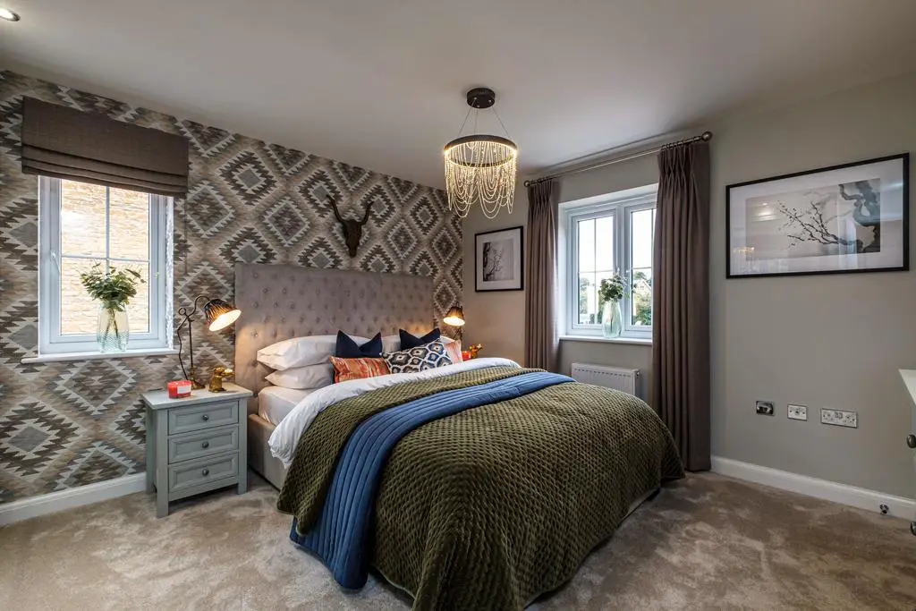 A dual aspect double bedroom with patterned...