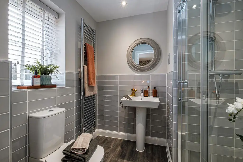 Shower room with grey tiled walls