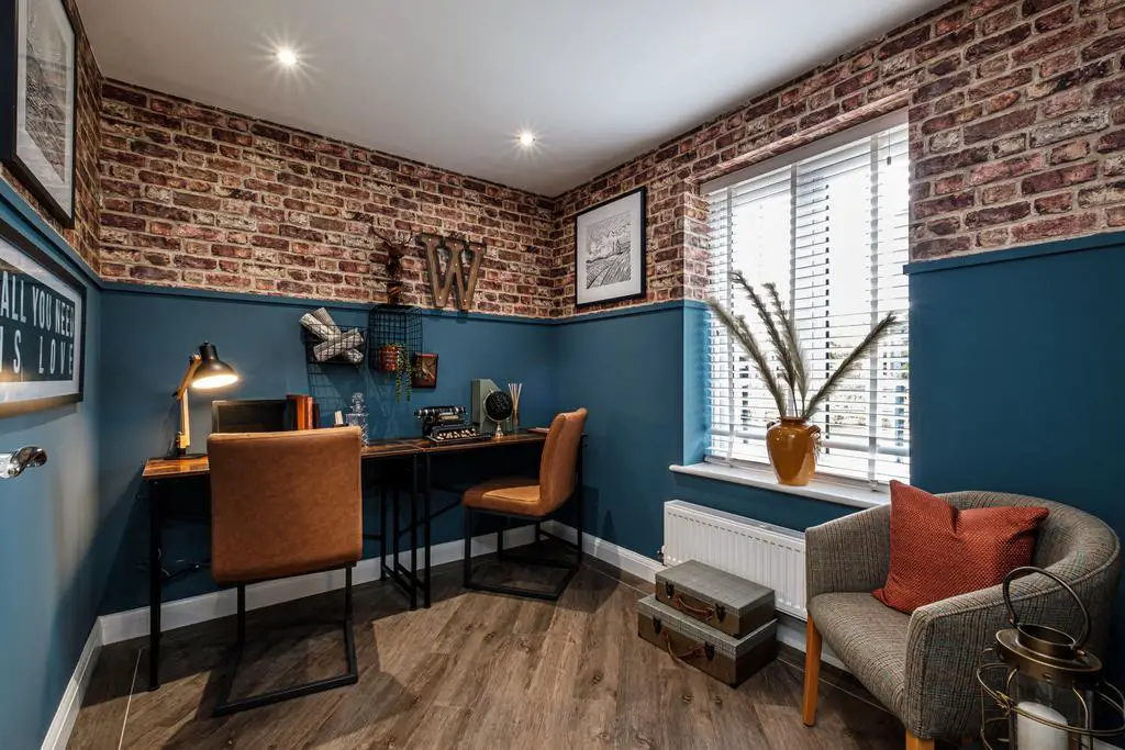 Study with brick patterned wallpaper above blue...
