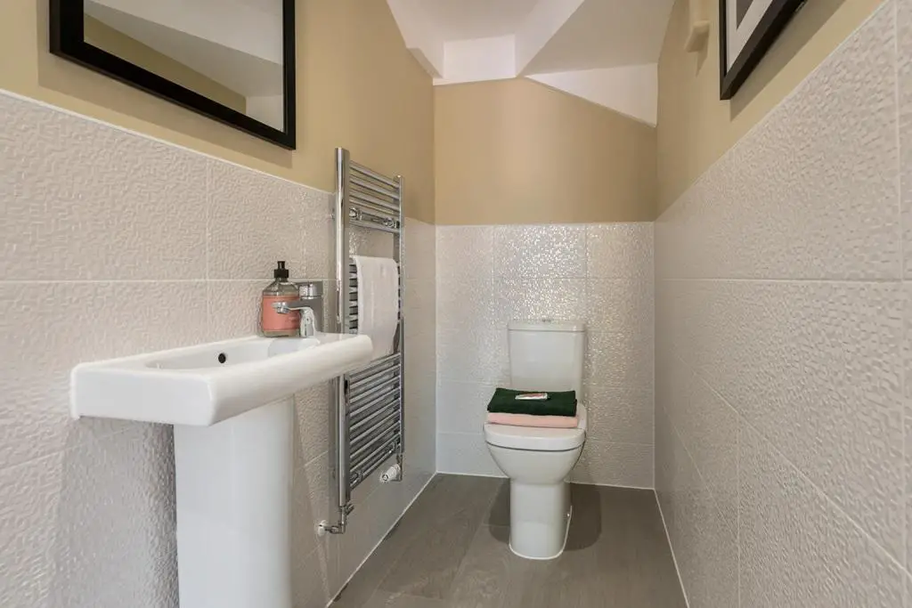 A convenient downstairs toilet sits in the...