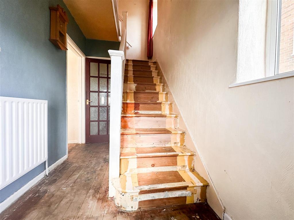 Stairs rising to first floor