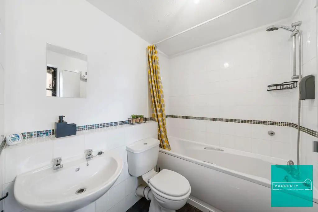 En Suite Bathroom with over bath shower and storag