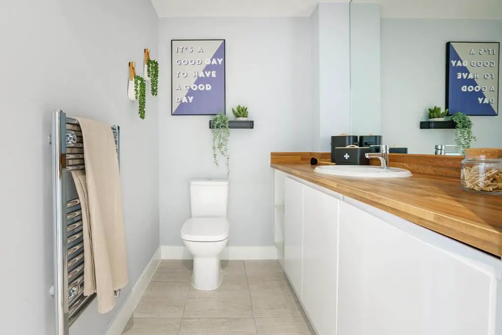 A cloakroom and utility area offers space for...