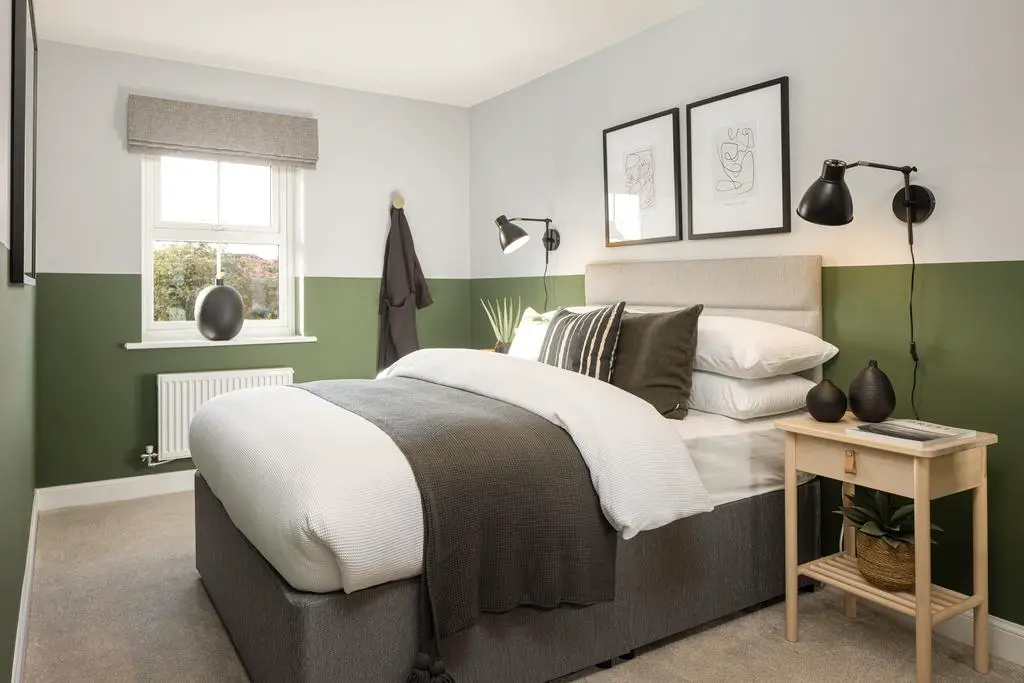 Green coloured double bedroom in a 3 bed home