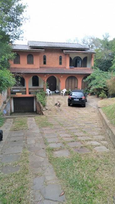 Foto 1 de Casa com 4 Quartos à venda, 279m² em Vila Nova, Porto Alegre
