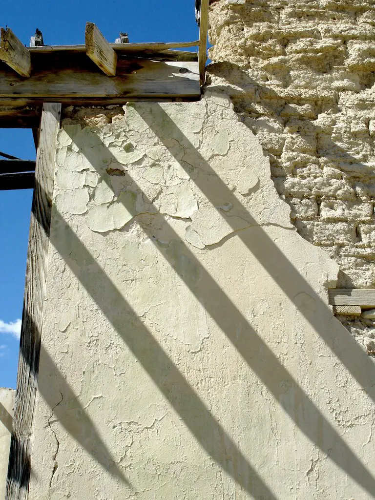 Terlingua School: Part of the ruined adobe wall and roof with afternoon shadows