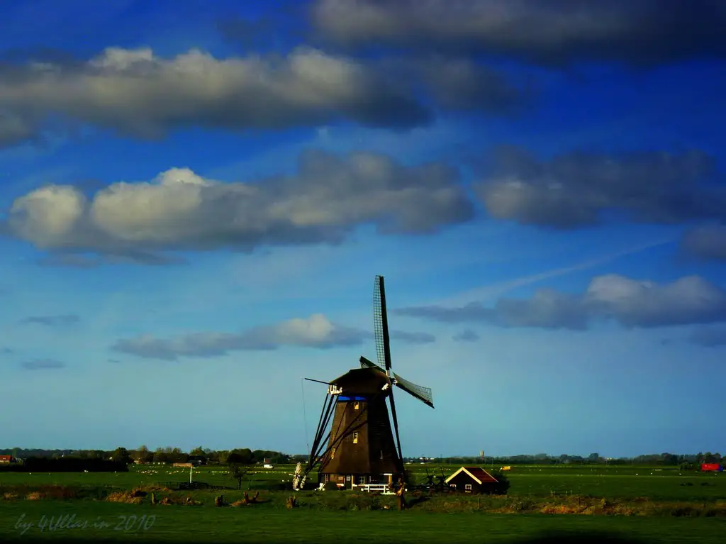 Classic Dutch windmill from the Fira Highspeed train from Schipol to Rotterdam, The Netherlands