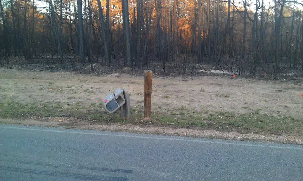 Melted mailbox after the forest fire